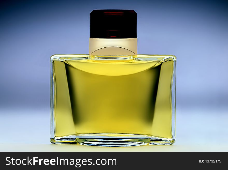 Isolated bottle of perfume on light blue backdrop