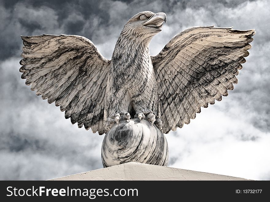 Victorious Eagle of Marble spreading his wings and sitting on the Globe