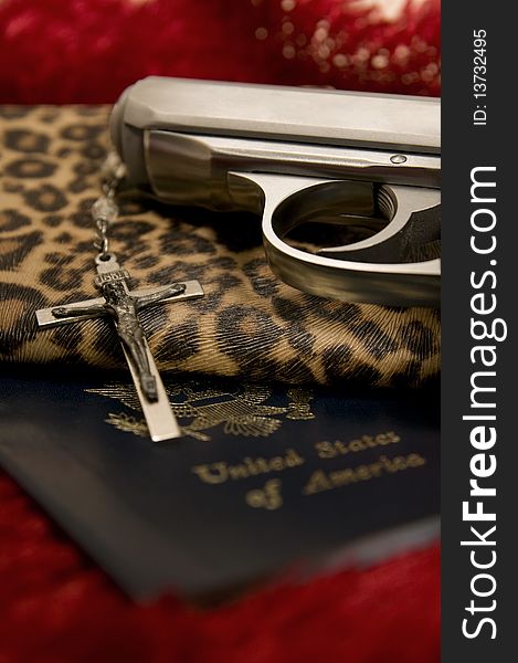 Silver Gun, Cross, Passport and women's animal skin clutch purse. Silver Gun, Cross, Passport and women's animal skin clutch purse