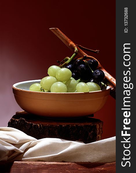 Still life of black and white grapes in a bowl. Still life of black and white grapes in a bowl