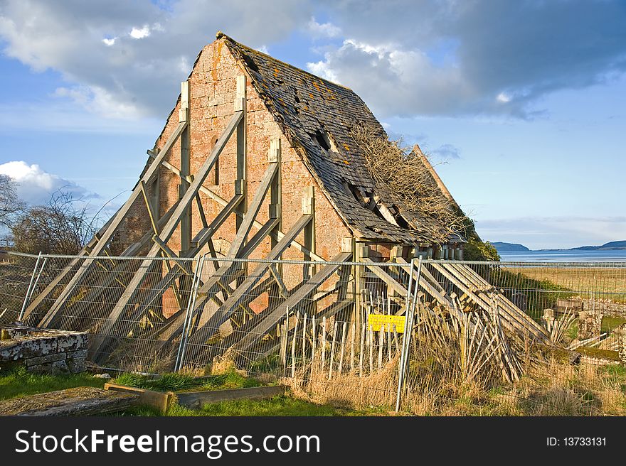 Derelict House Propped Up By Planks.