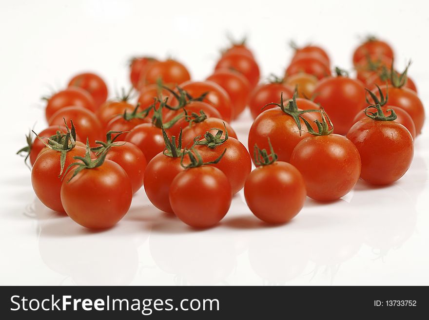 Crimson tomatoes on white background image