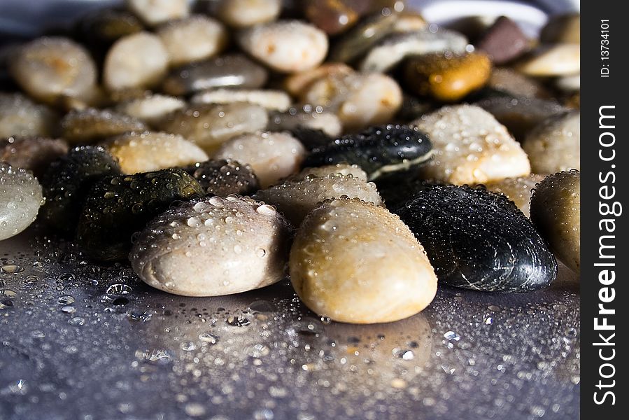 River rock sprinkled with water. River rock sprinkled with water