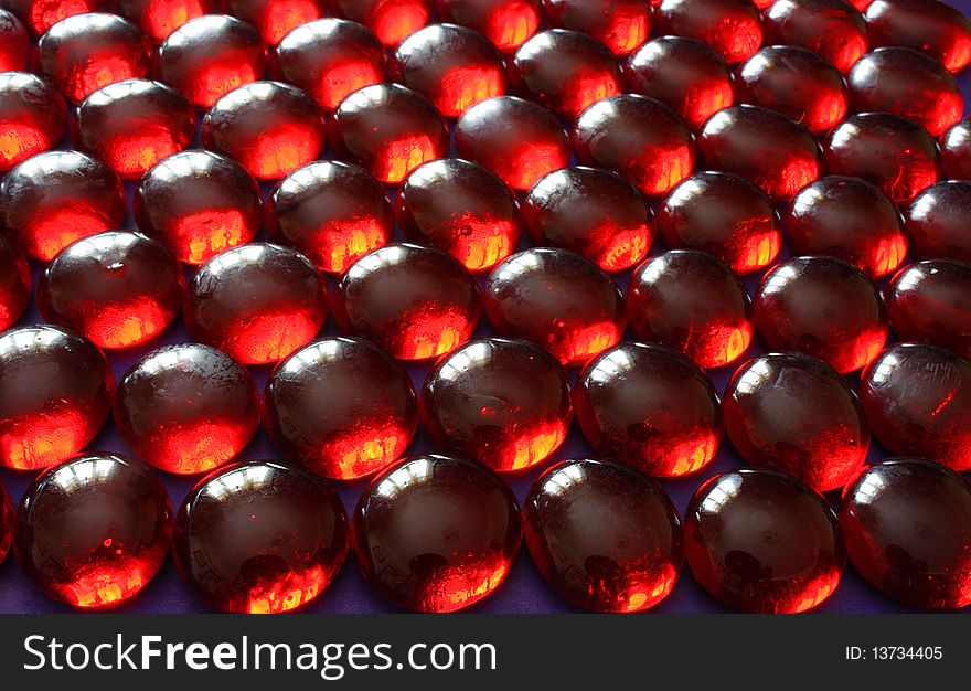 Abstract background consists of glass beads in red