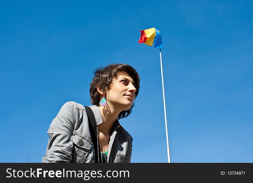 Young girl smiling with the Romanian flag in the background