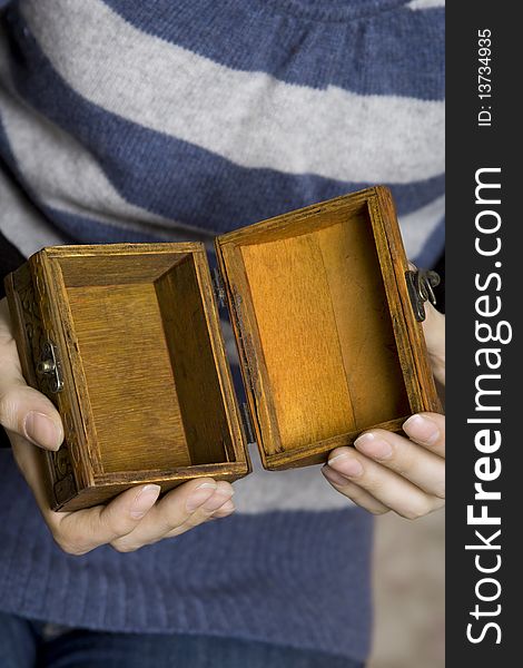 Hands of a young girl holding a decorative wooden box. Secret. Hands of a young girl holding a decorative wooden box. Secret