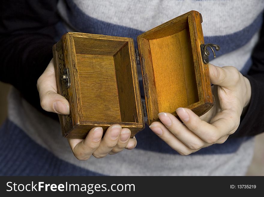 Hands of a young girl holding a decorative wooden box. Secret. Hands of a young girl holding a decorative wooden box. Secret