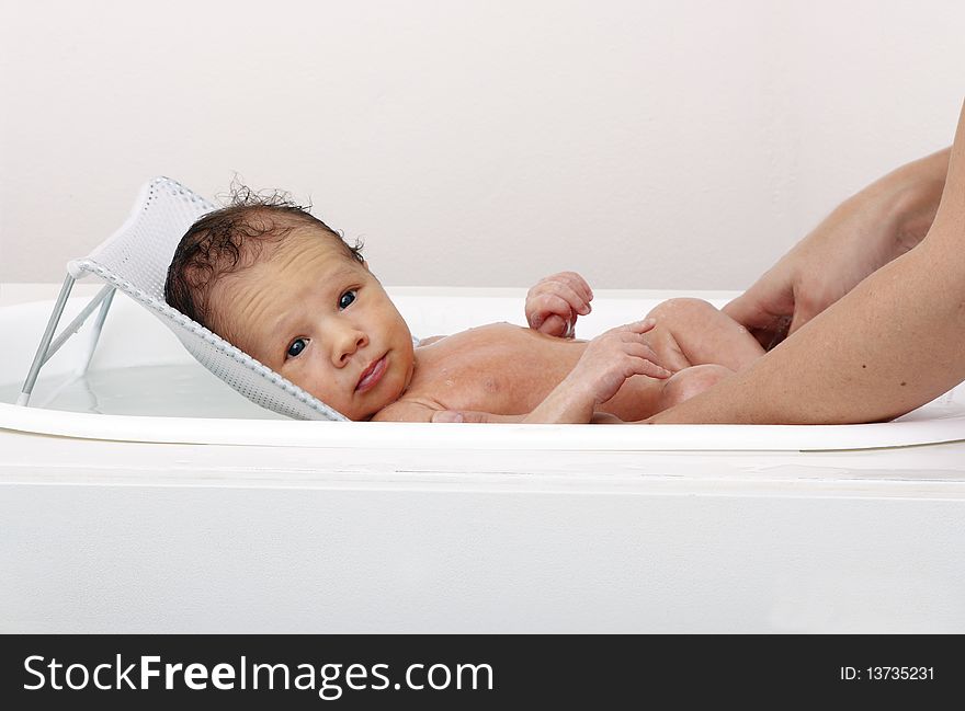 High-key shot of a baby in a bath. High-key shot of a baby in a bath.