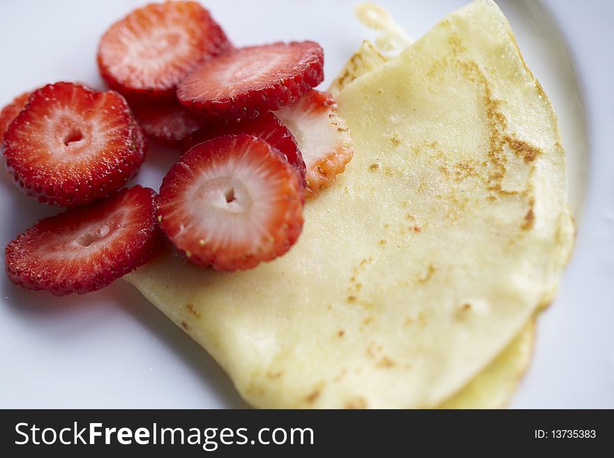 Thin pancake or crepes with sliced strawberries. Thin pancake or crepes with sliced strawberries