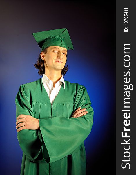 Portrait of a succesful man on his graduation day in green clothes and a hat