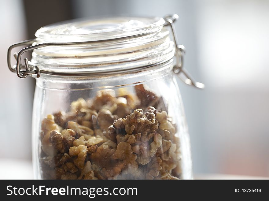 Glass jar with walnuts for storage