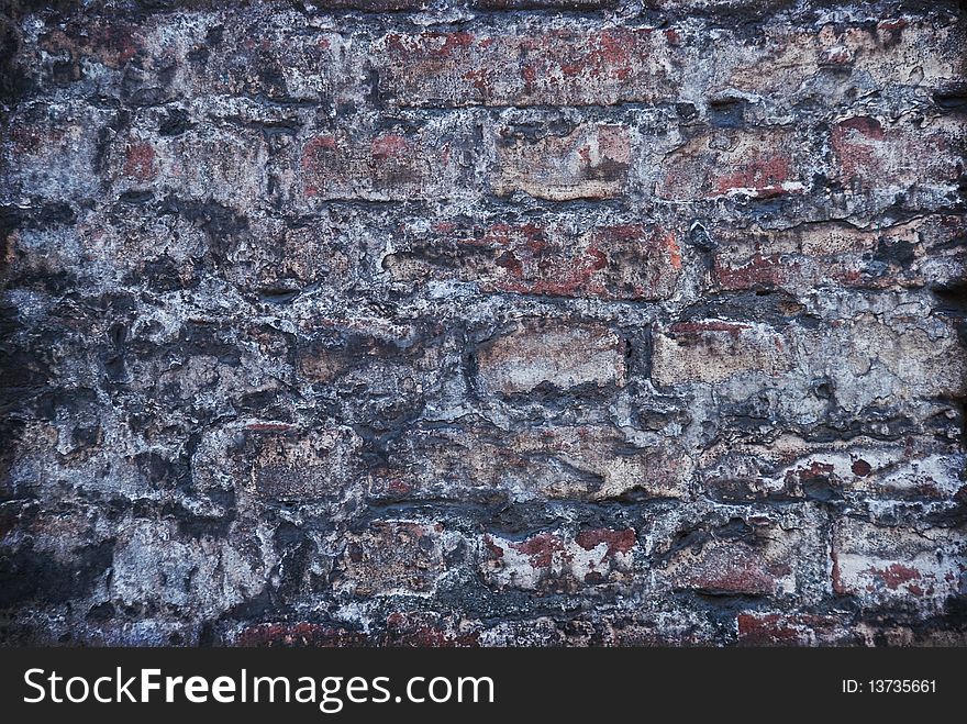 Old grey brick wall - background in grunge style