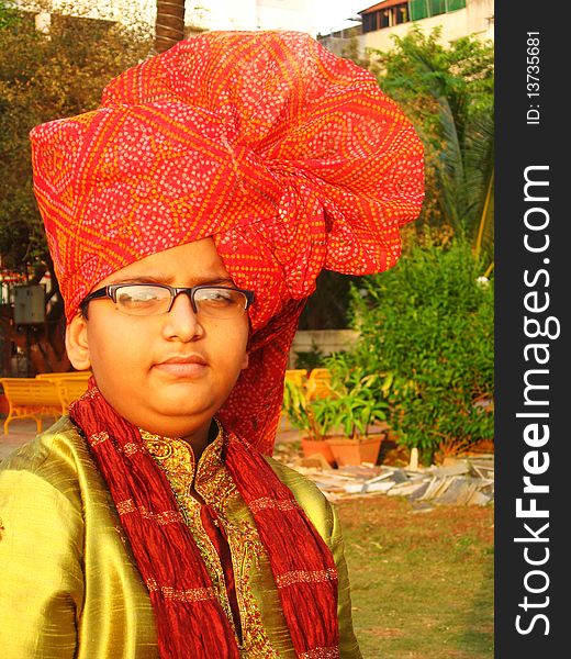 A rich Indian boy with red turban from a village.