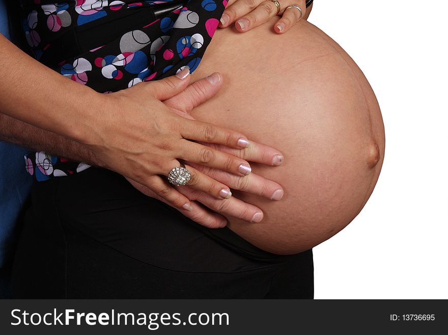 A Couples Hands On A Pregnant Belly.