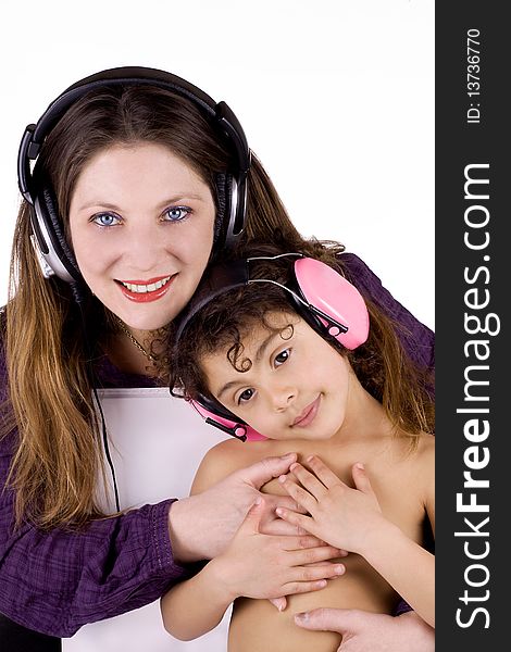 Woman with her mulatto girl listening to music. Woman with her mulatto girl listening to music