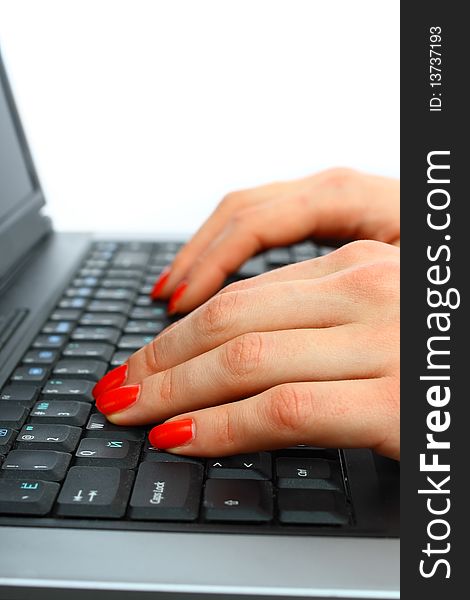 Fingers typing on a modern laptop keyboard