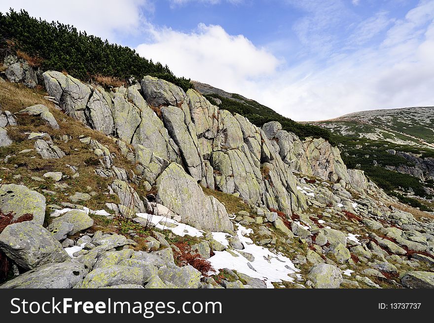 High mountains scape with boulders and snow