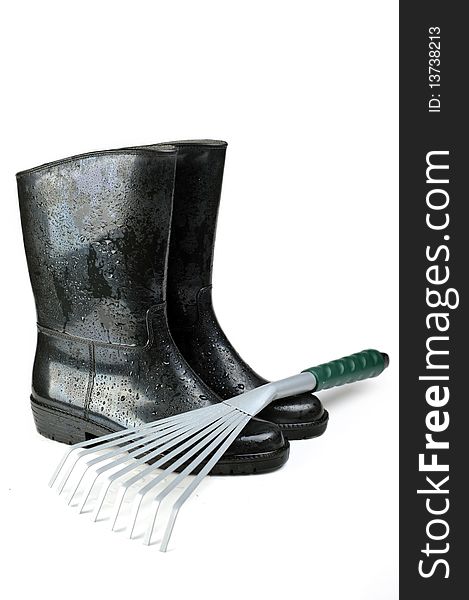 Gardening tools: rubber boots and rake