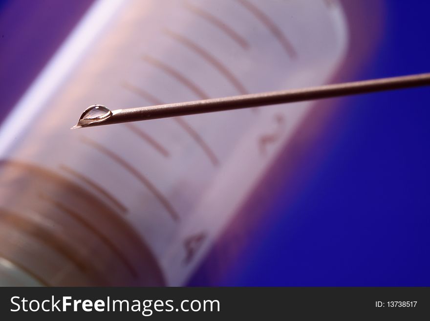 Needle syringe with drop of liquid. Needle syringe with drop of liquid