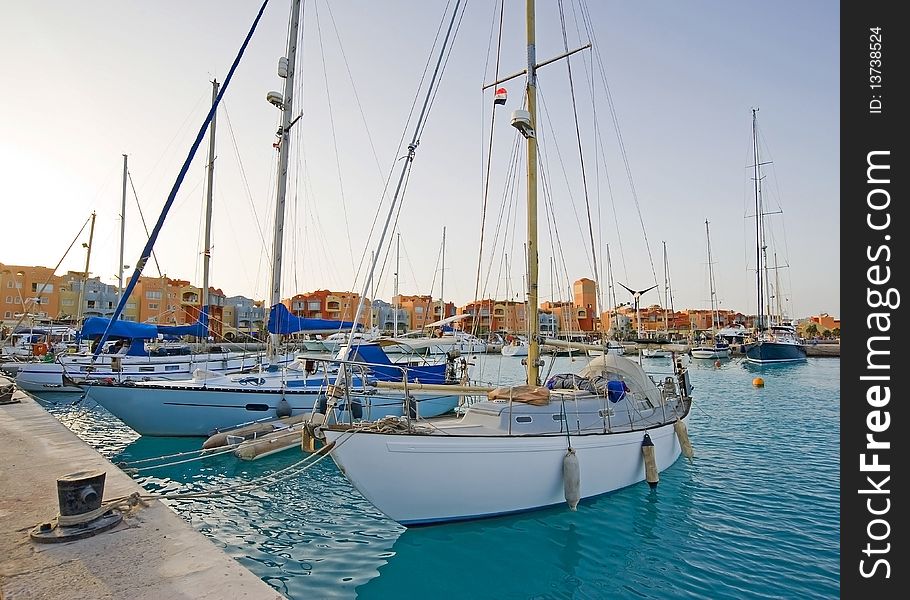 Sailing yachts moored in a private marina. Sailing yachts moored in a private marina