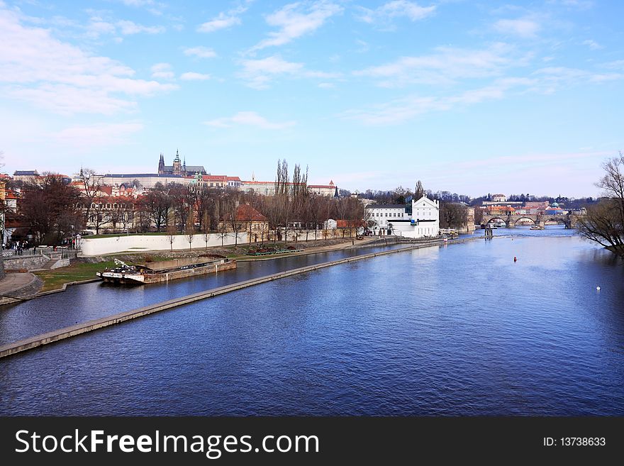 The panoramic View on spring Prague above River Vltava with gothic Castle
