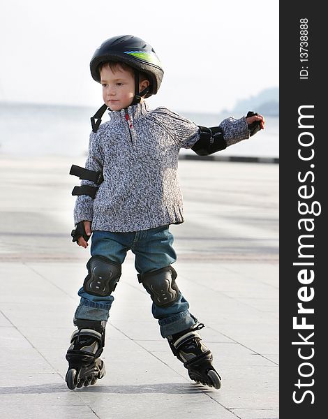 Outdoor portrait of young boy in roller blades