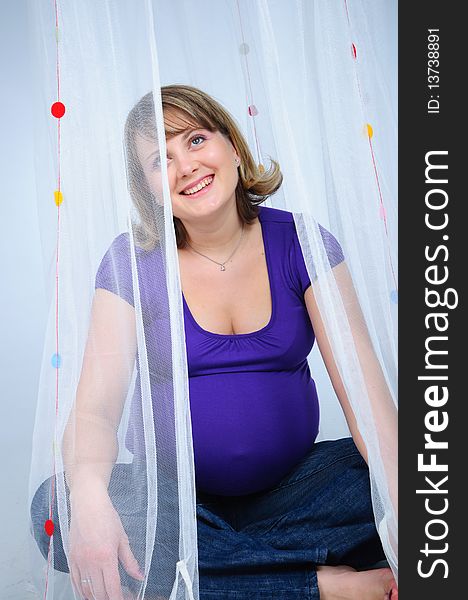 Young cute pregnant girl in studio