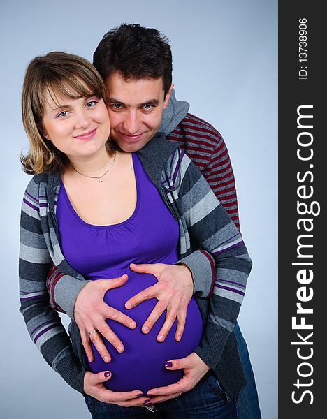 Happy young couple in anticipation of the twins in studio. Happy young couple in anticipation of the twins in studio