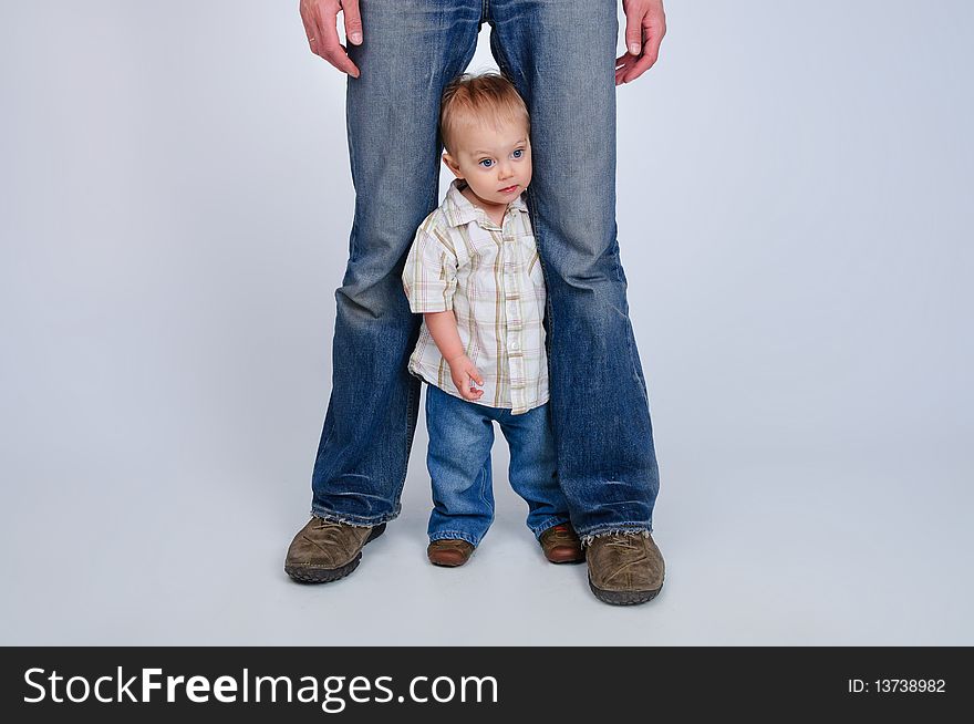 Studio shot of father and son in blue jeans