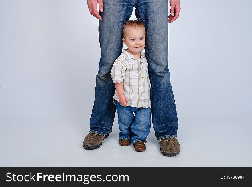 Studio shot of father and son in blue jeans