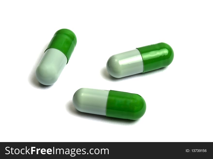 Green capsules isolated on white
