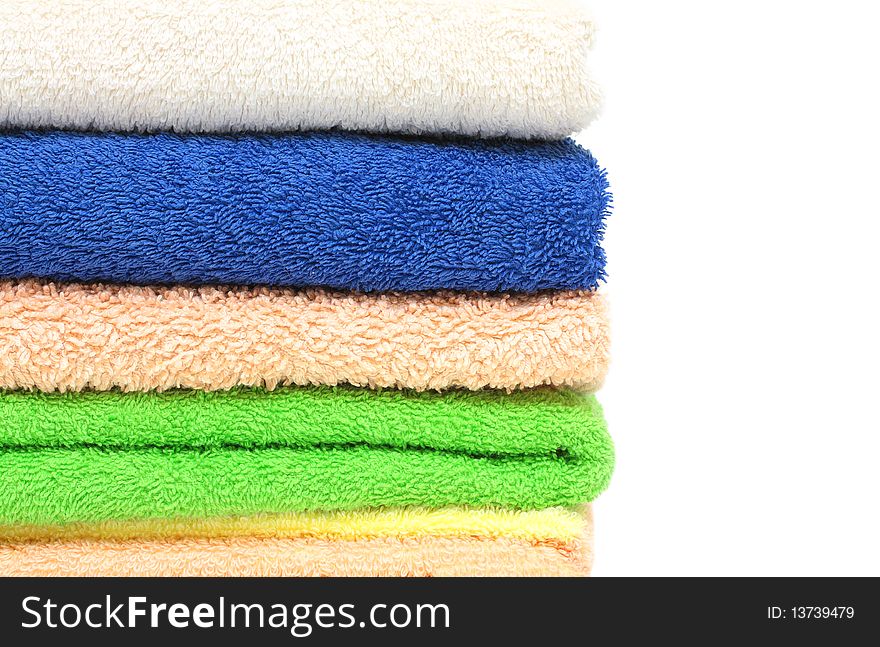 Multicolour towels stacked, isolated on white background