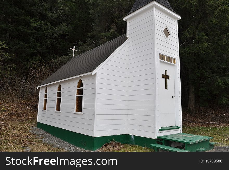 Petite white church showing windows and front door. Petite white church showing windows and front door