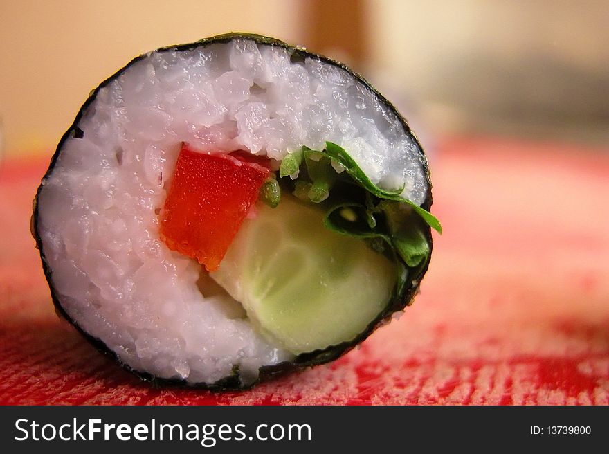 A vegetarian sushi made with cucumber, pepper and parsley. A vegetarian sushi made with cucumber, pepper and parsley