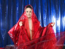 Woman In Red Silk On Blue Background Royalty Free Stock Photography