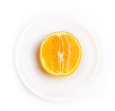 Slice Of Orange On White Plate Royalty Free Stock Photo