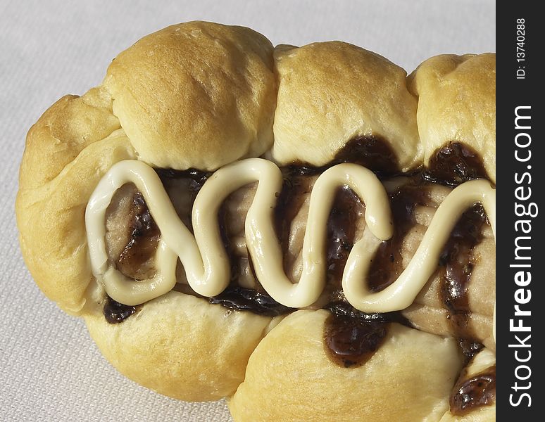 Braided bread with sausage and decorative toppings
