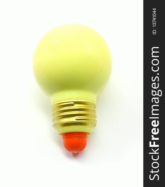 A toy yellow light bulb isolated could be used to show and idea concept or energy.