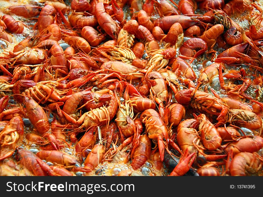 Louisiana crawfish boiling in a pot of spicy water.