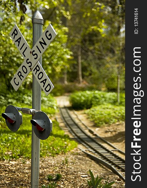 Railroad crossing sign with tracks