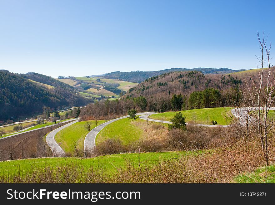 Zigzag country road in the spring. Zigzag country road in the spring