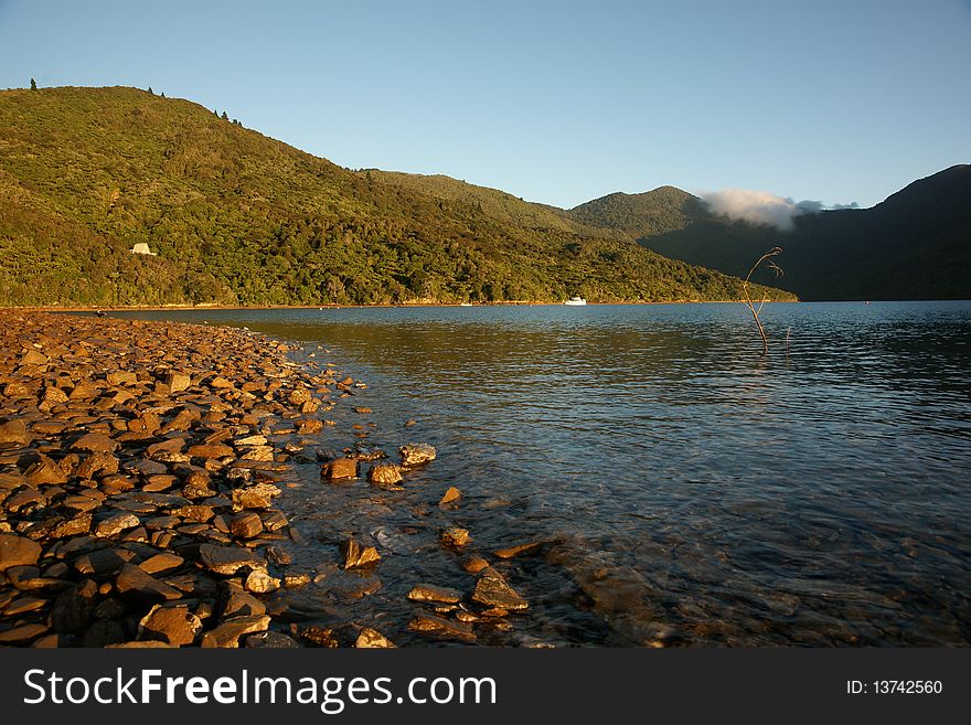 Golden light on stoney foreshore.