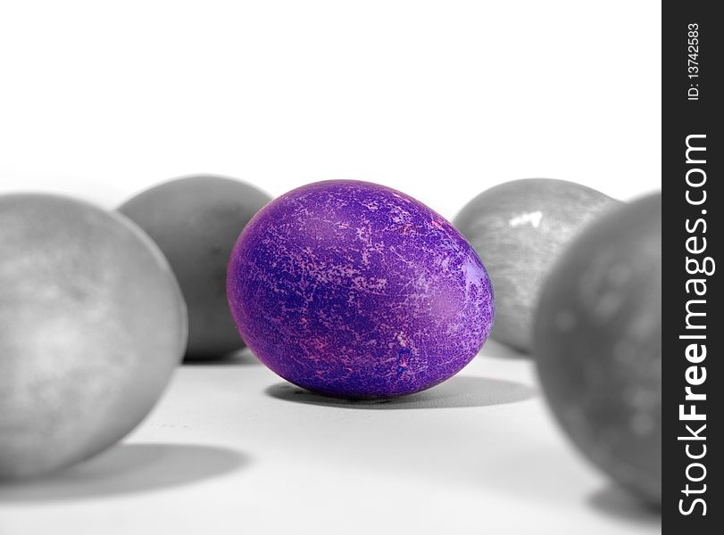 One bright purple Easter egg stands alone in a dark, dreary colourless world.
 . One bright purple Easter egg stands alone in a dark, dreary colourless world.