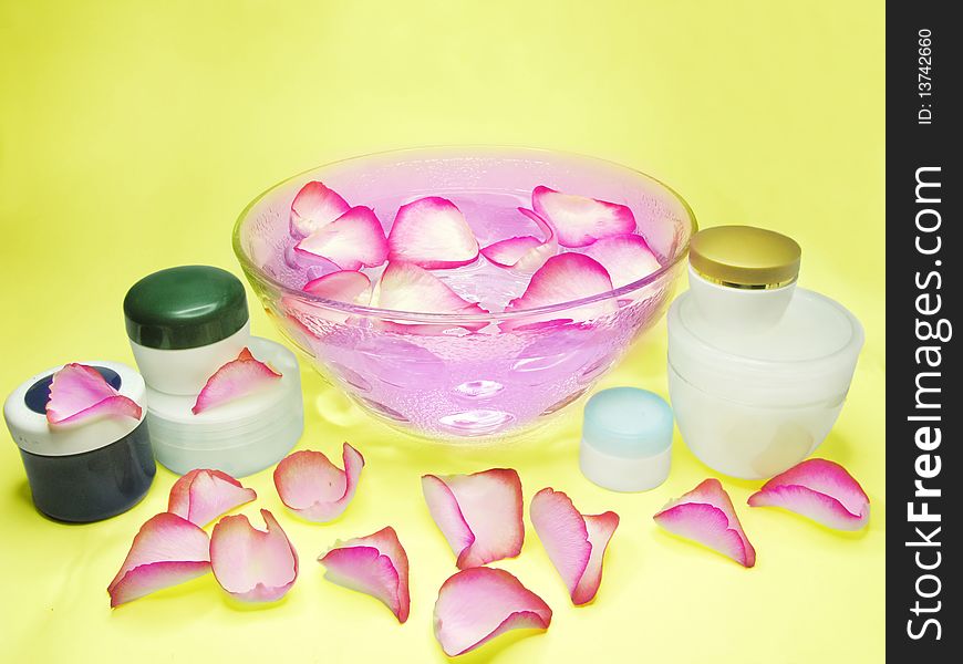 Spa bowl with rose petals and cremes