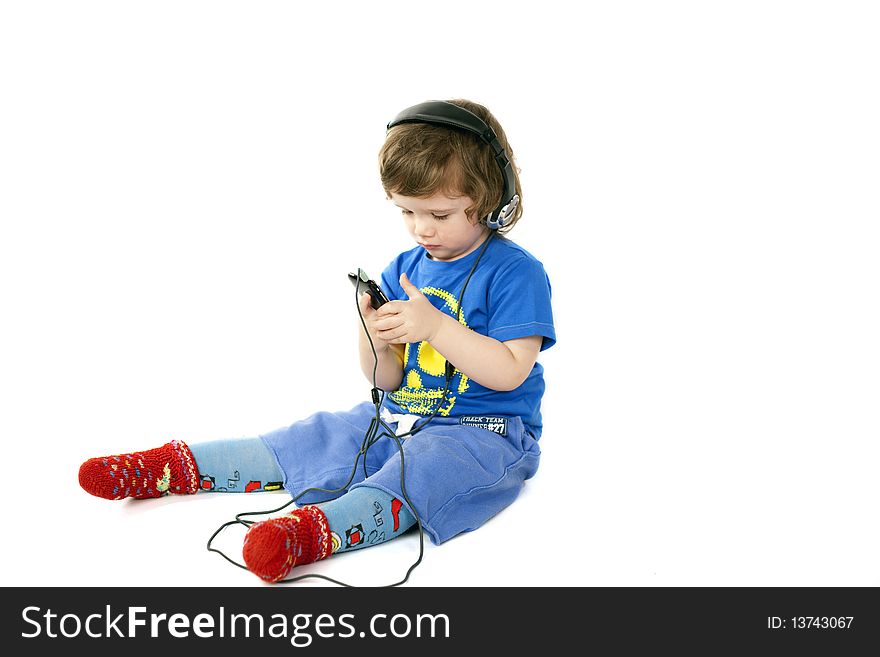 Cute serious child looking in his Mp3 player. Cute serious child looking in his Mp3 player