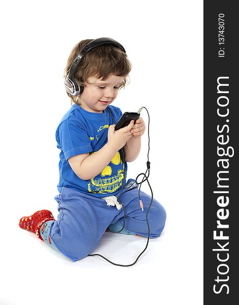 Cute child with headphones and a Mp3 player in hands. Cute child with headphones and a Mp3 player in hands