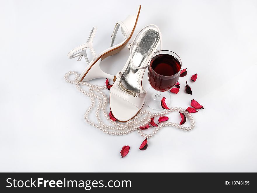 Women's shoes next to a glass and an emotional image. Women's shoes next to a glass and an emotional image