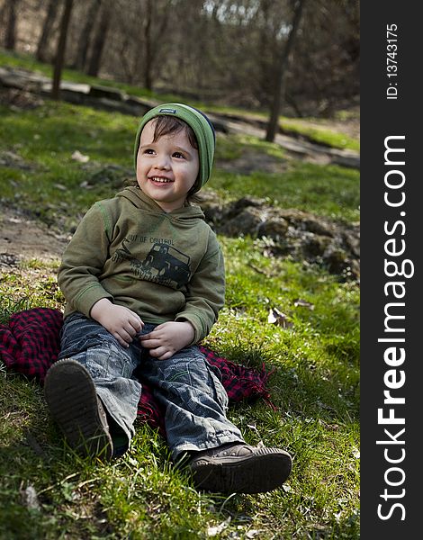 Cute child with green hat looking away. Cute child with green hat looking away