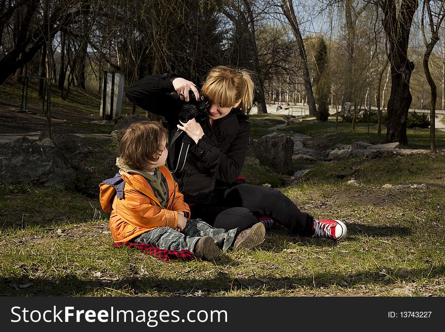 Woman taking pictures of her cute son. Woman taking pictures of her cute son
