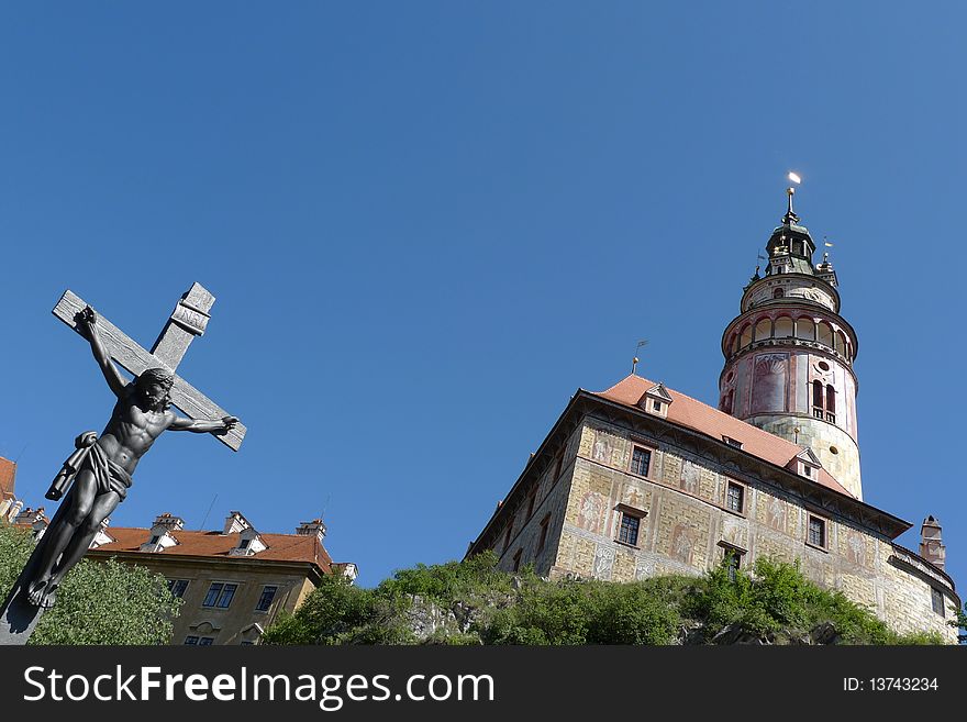 Cross of jesus and  the church in Cesky Krumlov of Czech. Cross of jesus and  the church in Cesky Krumlov of Czech.